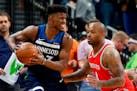Jimmy Butler, left, keeps the ball close as the Rockets' PJ Tucker defends during the second half of Game 3