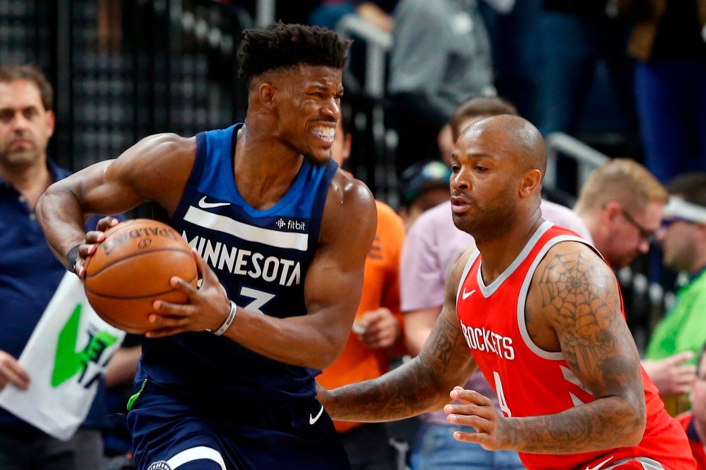 Jimmy Butler, left, keeps the ball close as the Rockets' PJ Tucker defends during the second half of Game 3