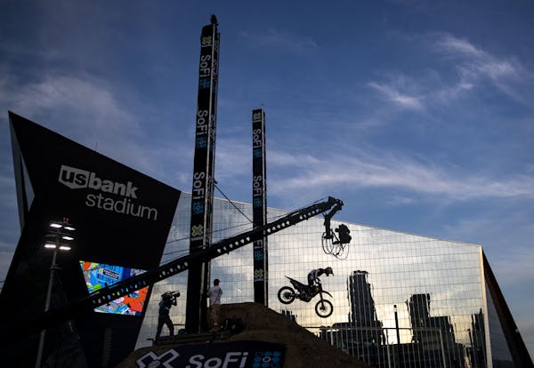 A Moto X rider clears the pole during the Moto X Step Up event in front of U.S. Bank Stadium in Minneapolis, MN.