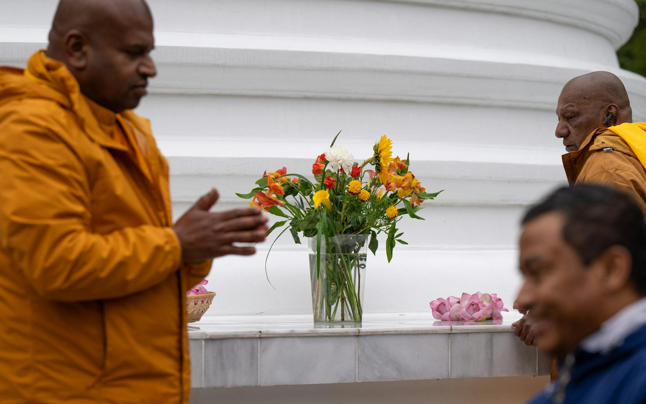 Founder of Minnesota Buddhist Vihara, Bhante Seewalie and visiting monk Ullala Chandima Thero placed flowers around the new Stupa Friday.