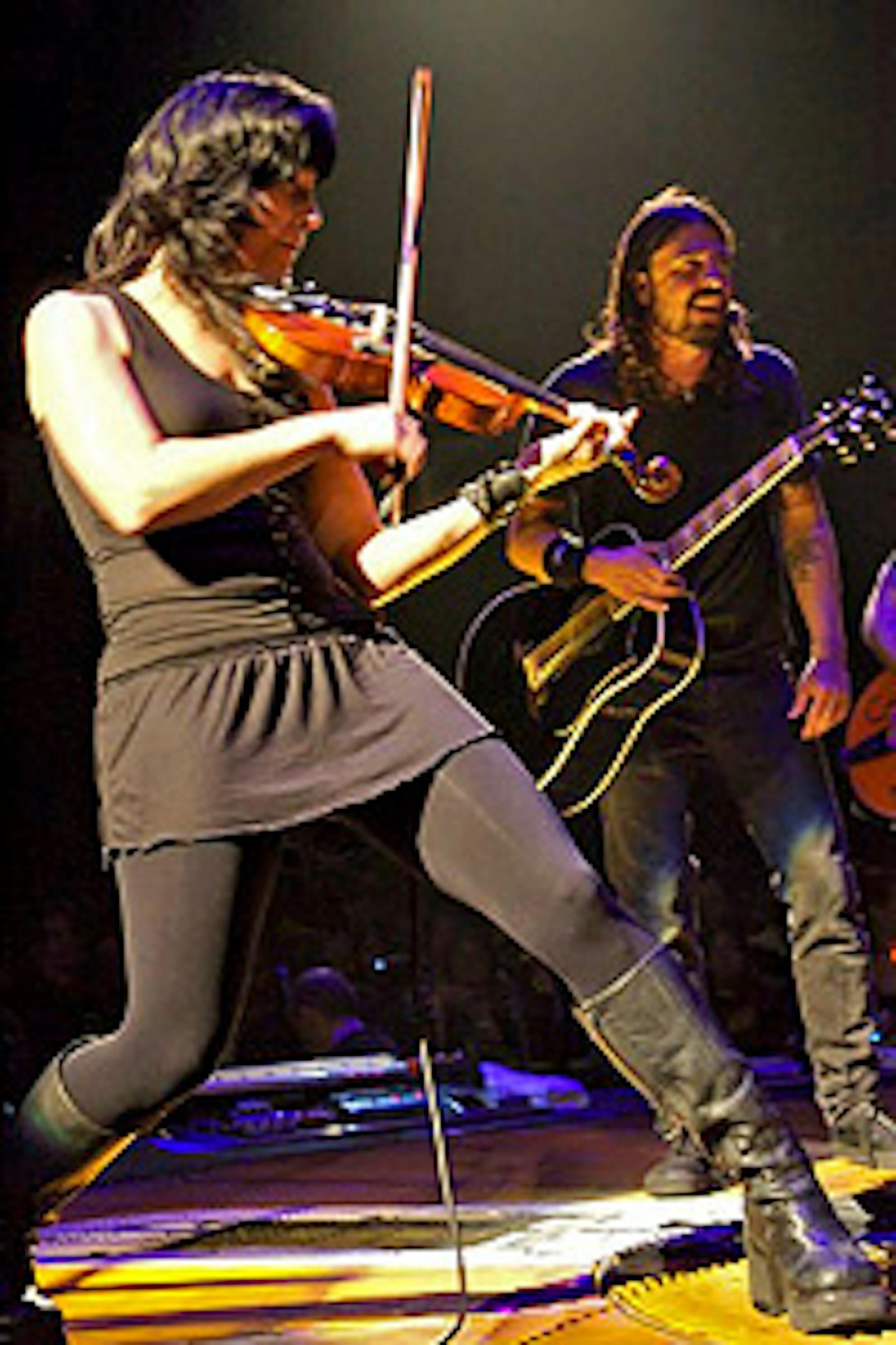 Jessy Greene onstage with Dave Grohl (rear) and the Foo Fighters.