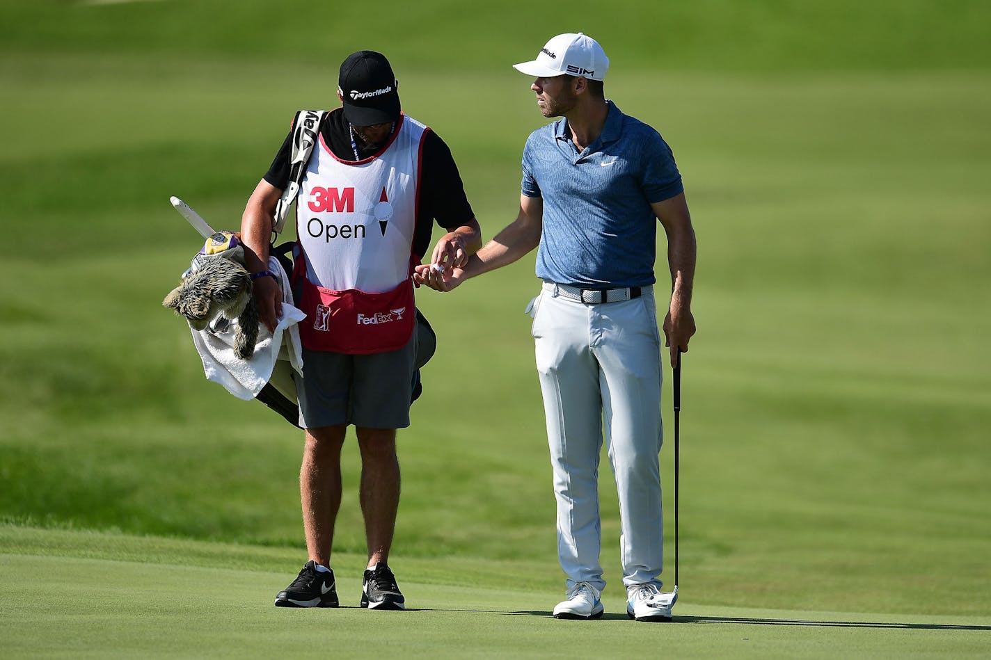 Matthew Wolff, right, talks with his caddie during the second round of the 3M Open on Friday, July 24, 2020, at TPC Twin Cities in Blaine, Minnesota. (Stacy Revere/Getty Images/TNS)