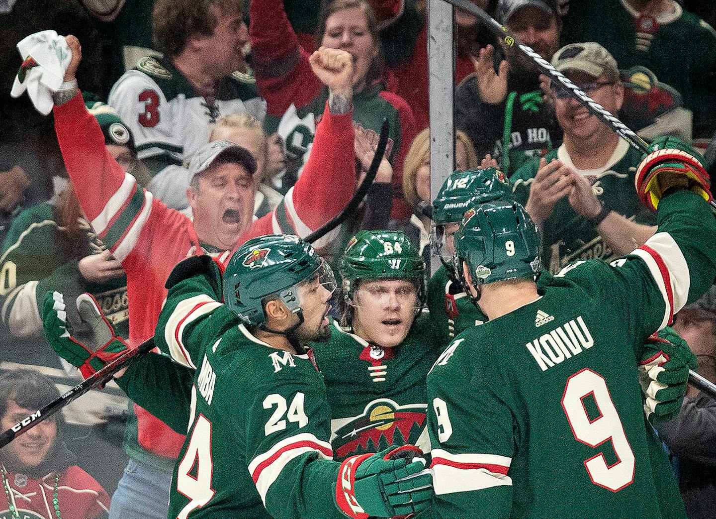 Mikael Granlund (64) celebrated with teammates after scoring a goal in the first period.