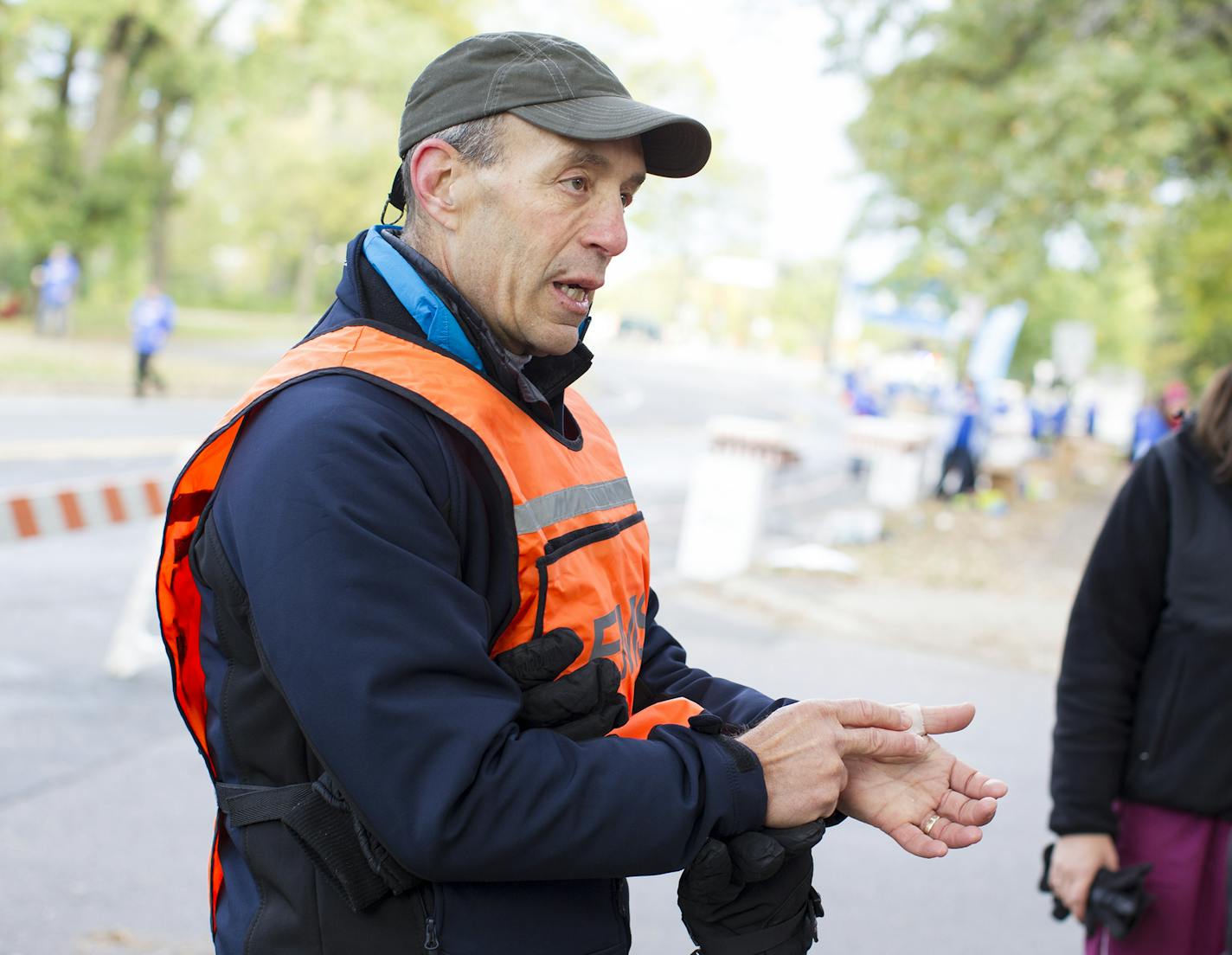 Dr. Jamie Peters shows fellow volunteers the best way to bandage a blister at a medical station on East River Parkway in Minneapolis during the Twin Cities Marathon October 5, 2014. (Courtney Perry/Special to the Star Tribune)