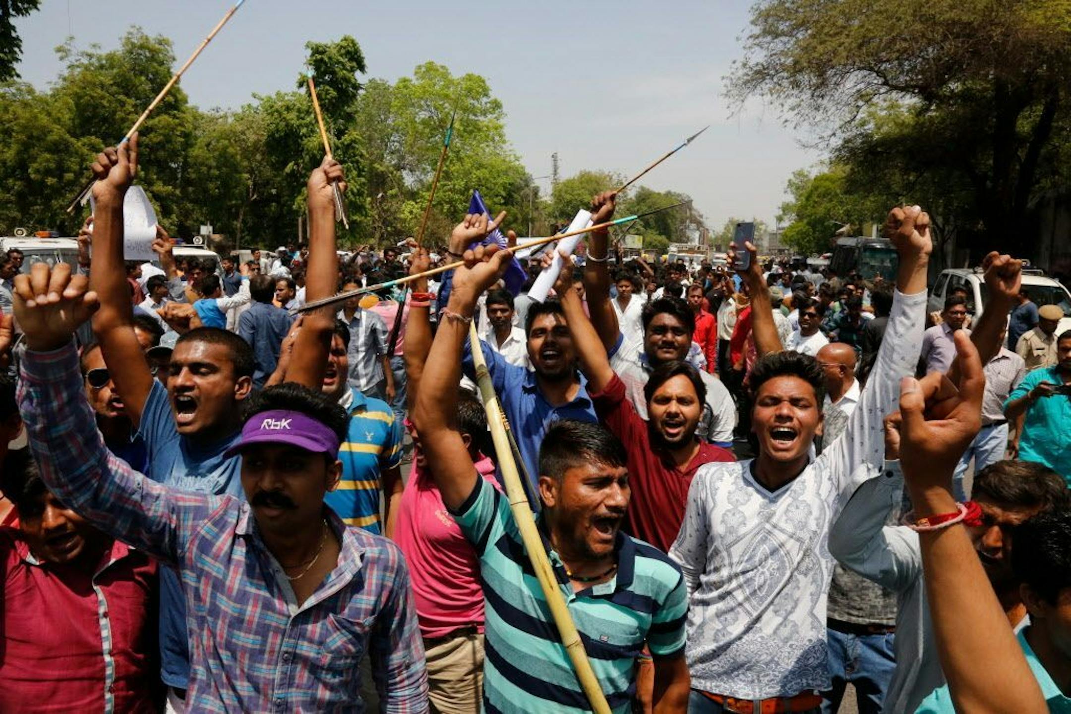 India's lower caste Dalits hold bow and arrows and shout slogans during a nationwide strike in Ahmadabad, India, Monday, April 2, 2018. Violence has erupted in several parts of north and central India as thousands of dalits, members of Hinduism's lowest caste, protest an order from the country's top court that they say dilutes legal safeguards put in place for their marginalized community.