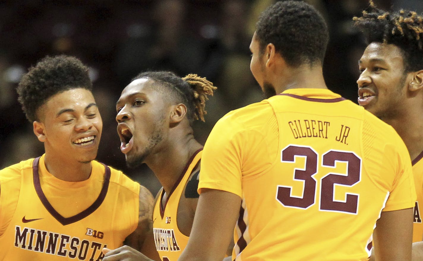 Minnesota's Nate Mason (2), Akeem Springs, center, Ahmad Gilbert Jr. (32) and Eric Curry (24) celebrate a play by Springs against Georgia Southern in the first half of an NCAAcollege basketball game Friday, Dec. 9, 2016, in Minneapolis. (AP Photo/Andy Clayton-King)