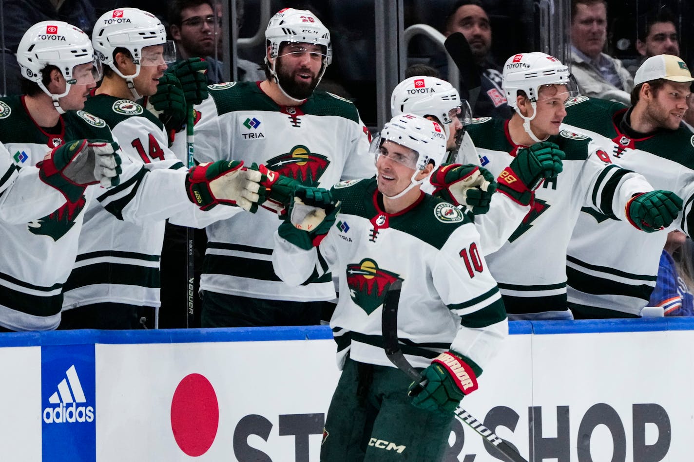 Minnesota Wild's Vinni Lettieri (10) celebrates with teammates after scoring a goal during the second period of an NHL hockey game against the New York Islanders Tuesday, Nov. 7, 2023, in Elmont, N.Y. (AP Photo/Frank Franklin II)