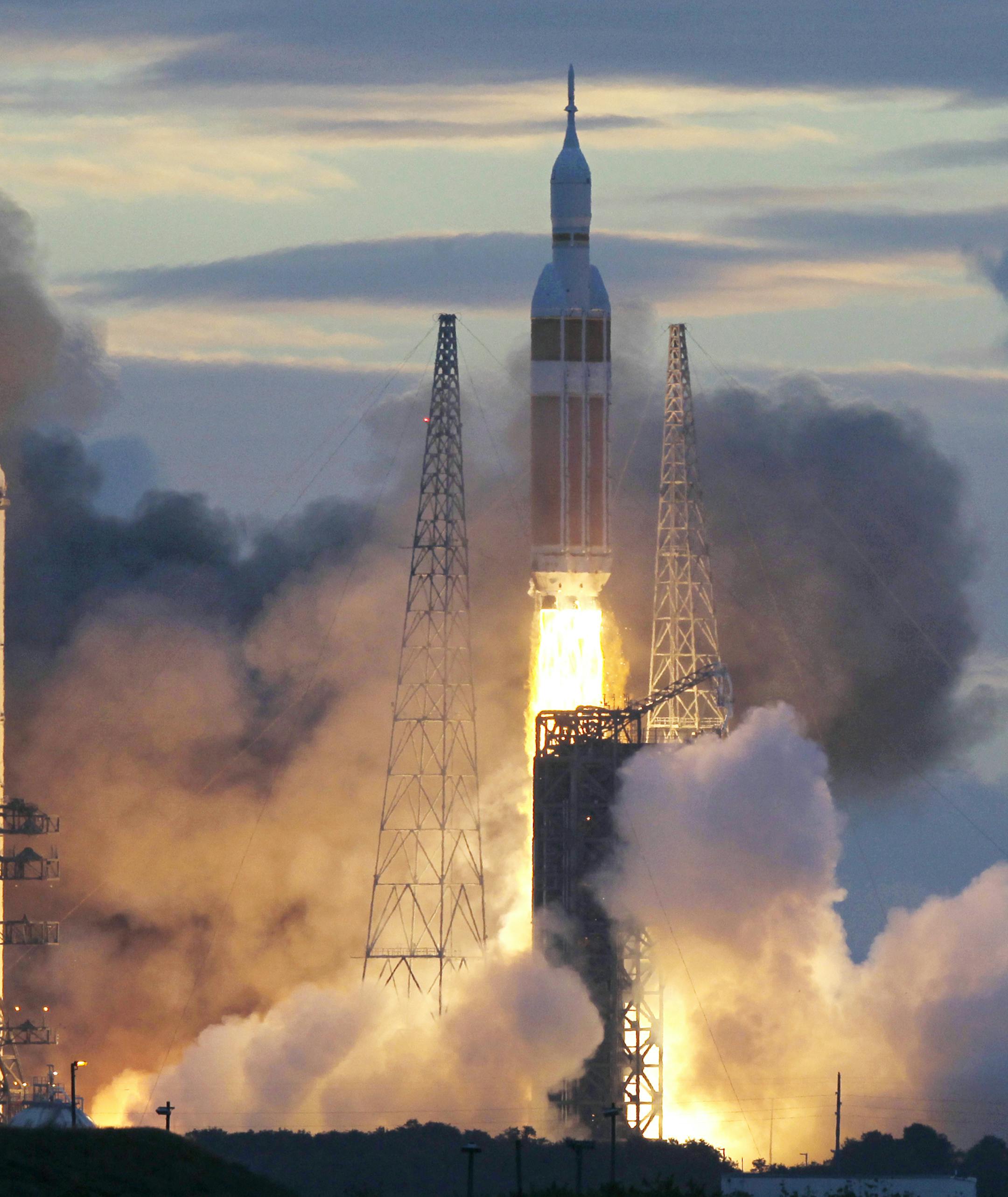 A NASA Orion capsule on top of a Delta IV rocket lifts off on its first unmanned orbital test flight from Complex 37 B at the Cape Canaveral Air Force Station, Friday, Dec. 5, 2014, in Cape Canaveral, Fla. (AP Photo/Marta Lavandier)