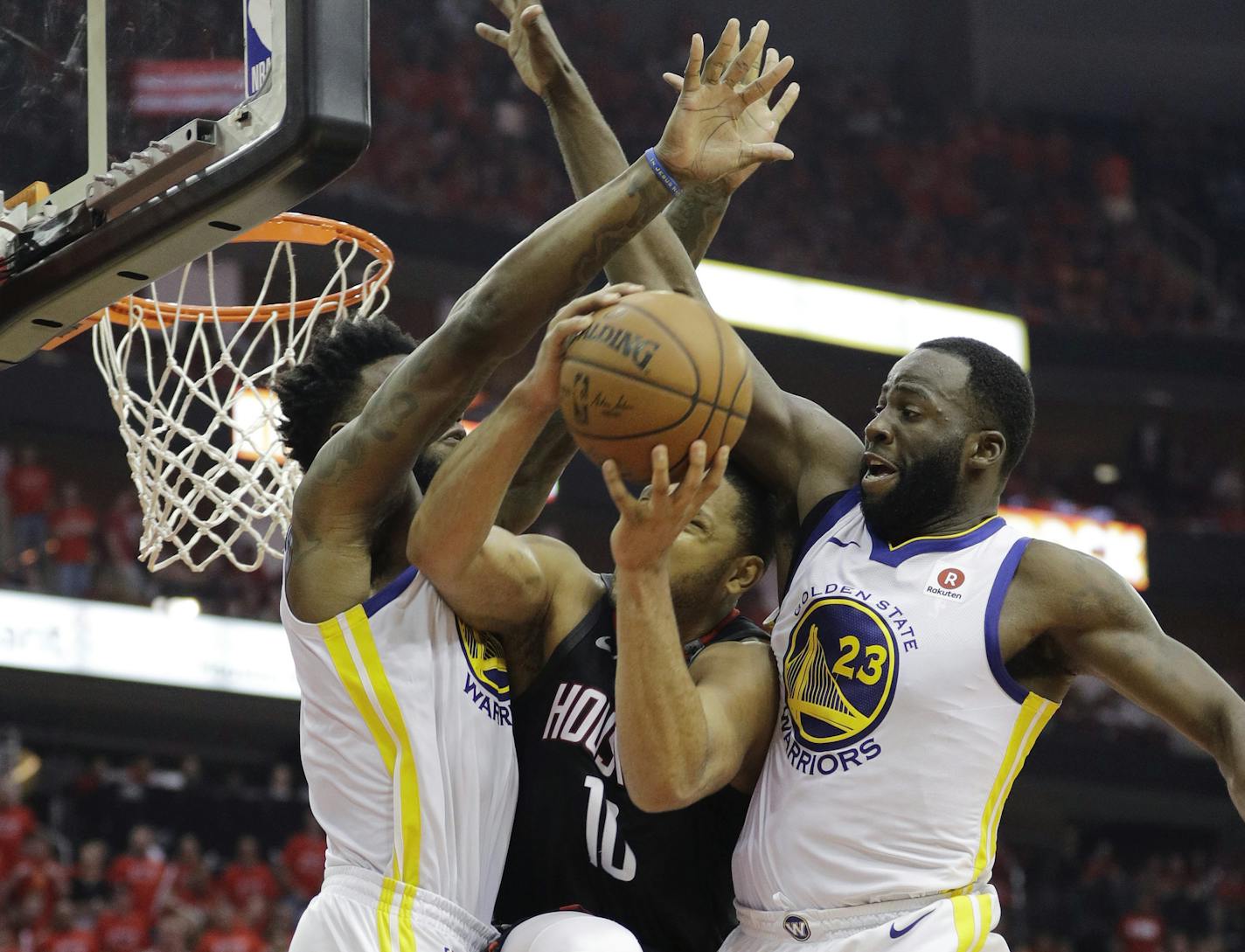 Houston Rockets guard Eric Gordon (10) is stopped by Golden State Warriors defenders Jordan Bell, left, and Draymond Green, right, as he tries to score during the second half in Game 7 of the NBA basketball Western Conference finals, Monday, May 28, 2018, in Houston. (AP Photo/David Phillip)