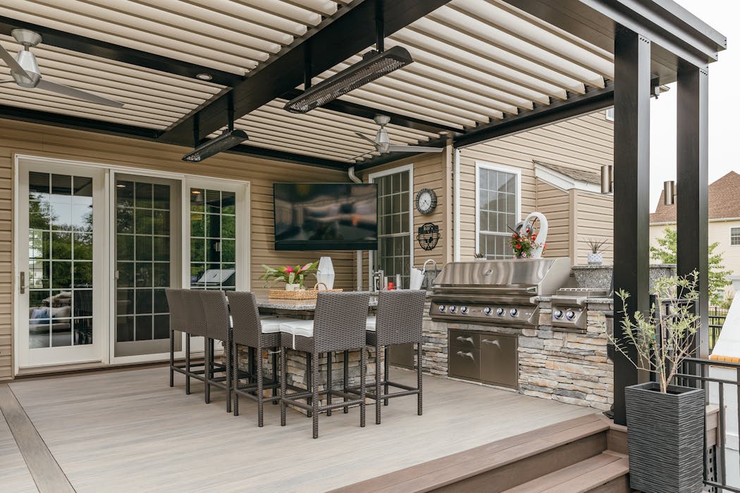 Bill Paliouras’s outdoor kitchen and dining area has a louvered ceiling, fans, infrared heat and a television.