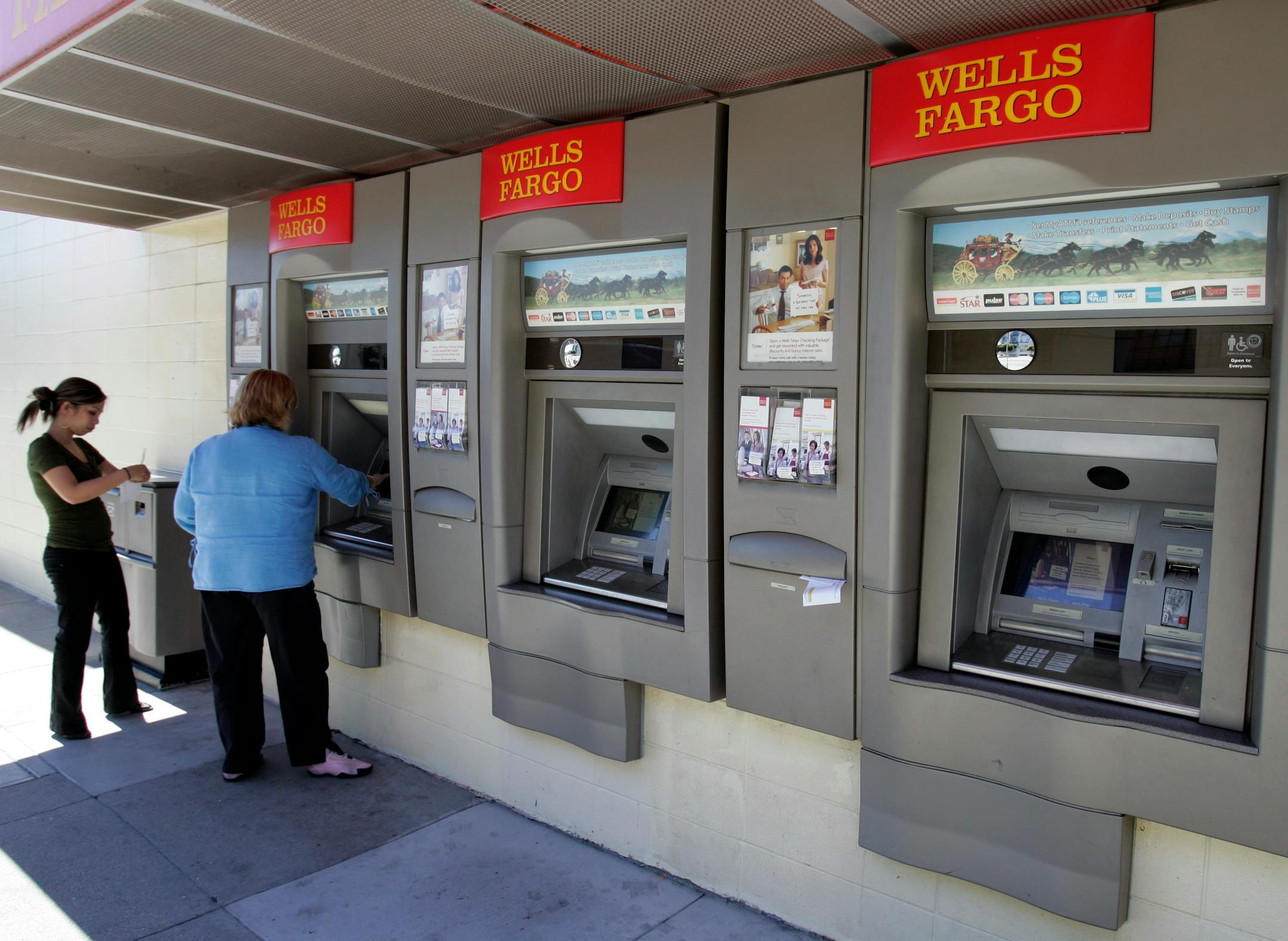 Customers use a Wells Fargo Bank ATM machine in San Francisco.