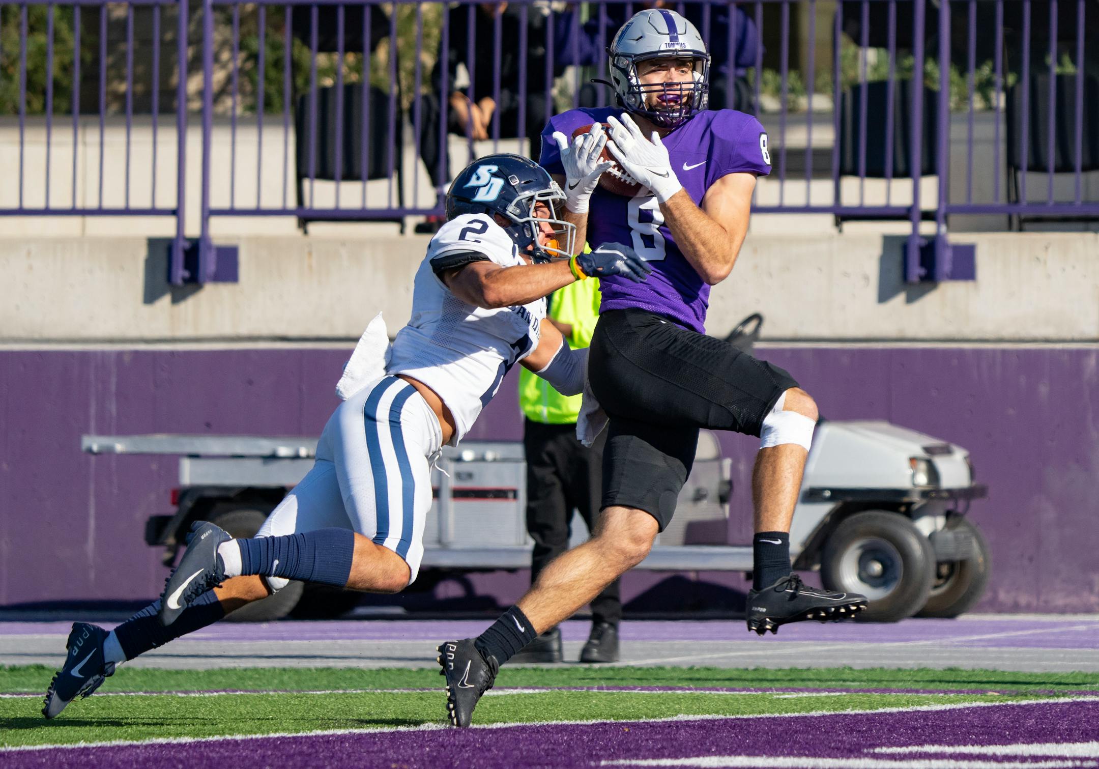 St. Thomas wide receiver Wesley Juszczak (8) catches a touchdown while being defended by San Diego Toreros cornerback Eric Haney (2) in the fourth quarter.