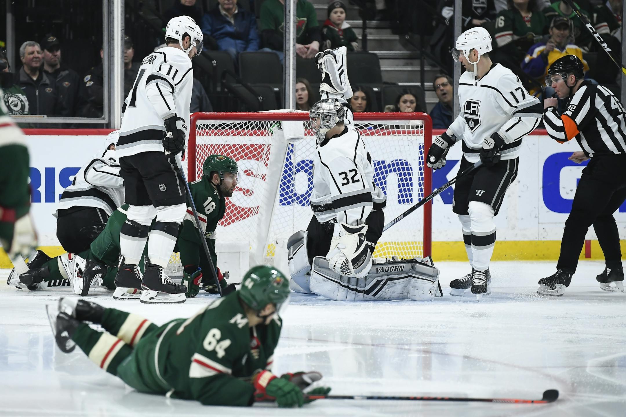 Minnesota Wild goaltender Alex Stalock (32) held the puck above his head after making a save in the second period against the Minnesota Wild.