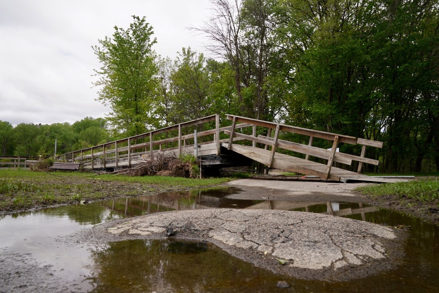 The fishing pier at Fort Snelling State Park was pushed ashore by the rising water at Snelling Lake.