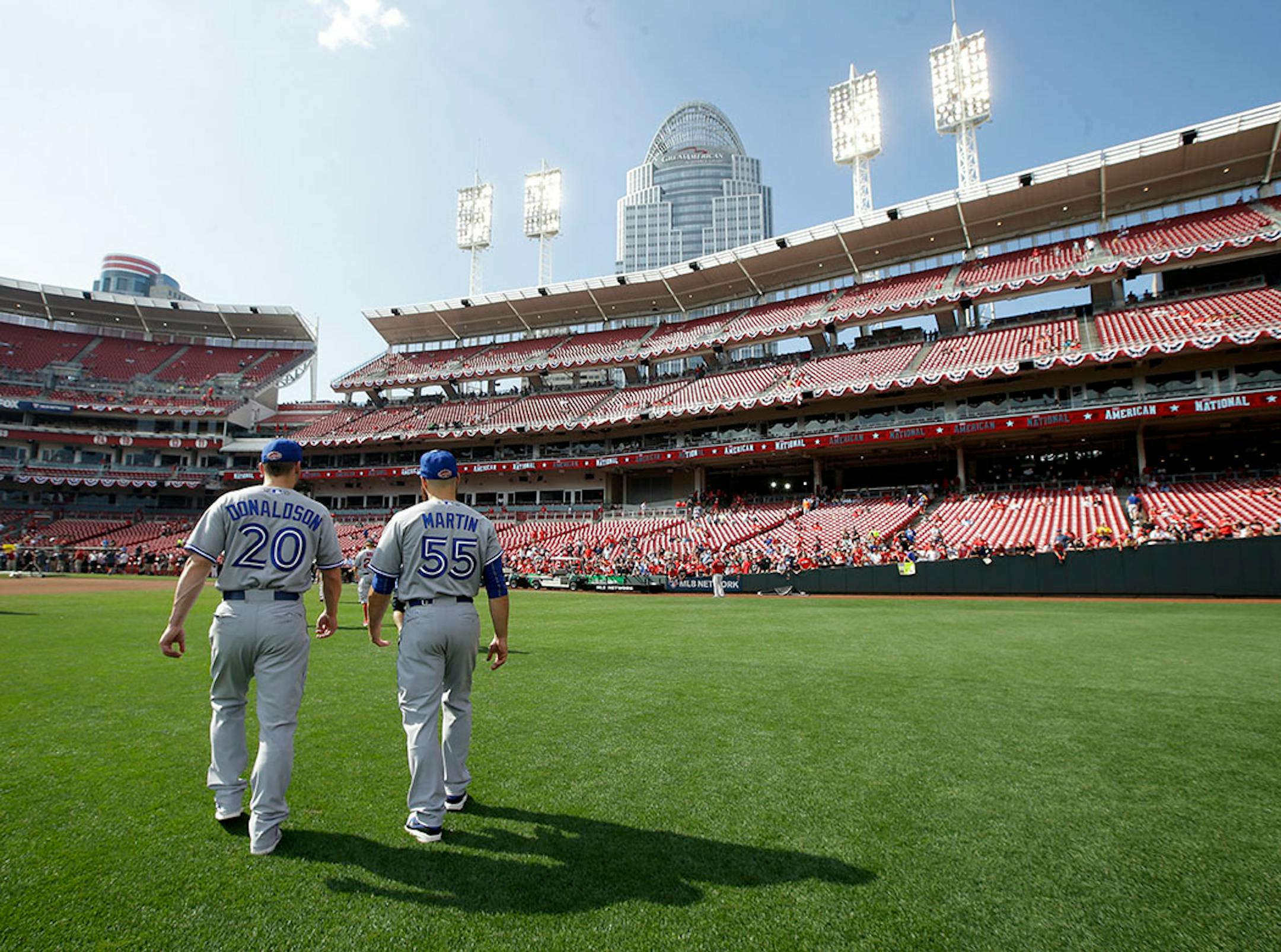 American League's Josh Donaldson, of the Toronto Blue Jays, and Russell Martin, of the Toronto Blue Jays, walk off the field following a team photo before the MLB All-Star baseball game, Tuesday, July 14, 2015, in Cincinnati.
