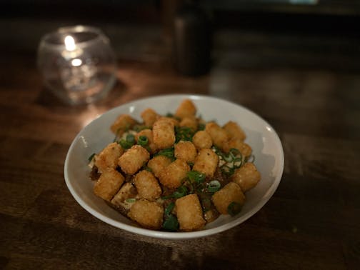 Ma Po hot dish is a bowl of the spicy tofu dish topped with tater tots.