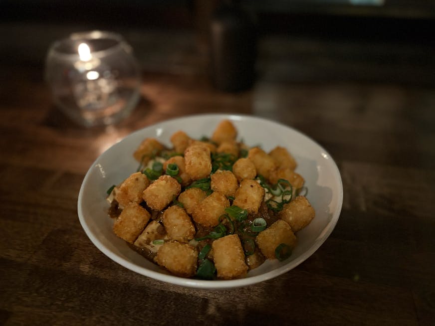 Ma Po hot dish is a bowl of the spicy tofu dish topped with tater tots.