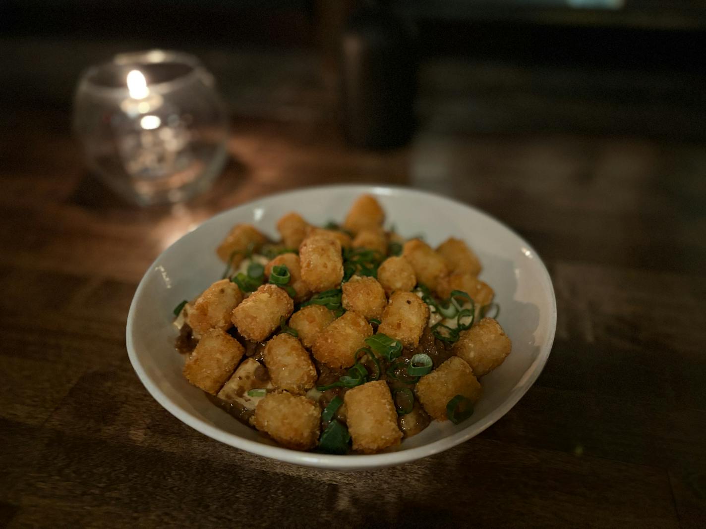 Ma Po hot dish is a bowl of the spicy tofu dish topped with tater tots.