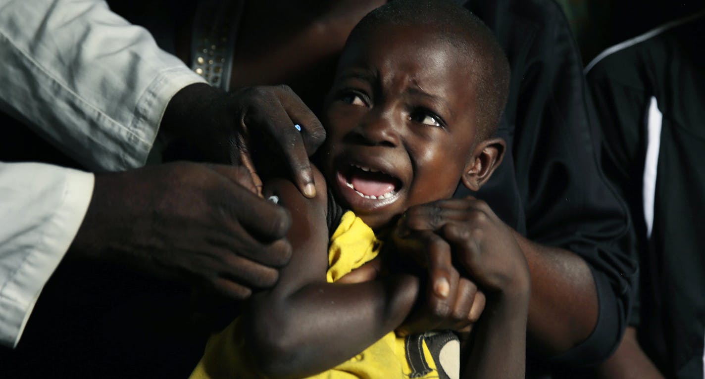 A boy reacts as he receives a yellow fever vaccine injection in the Kisenso district of Kinshasa, Congo, on Thursday, July 21, 2016. Yellow fever is not highly contagious and is easily prevented with vaccines. The disease is thought to have evolved in Africa about 3,000 years ago and was likely brought to the Americas by slave ships from West Africa. (AP Photo/Jerome Delay)