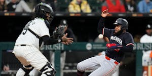 The Twins' Manuel Margot, right, slides by White Sox catcher Martín Maldonado to score on a single from Carlos Correa during the eighth inning Tuesda