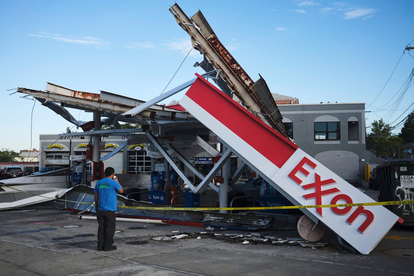 An Exxon gas station awning that collapsed during torrential rains from storms precipitated by Hurricane Ida, in the Queens borough of New York, Sept. 2, 2021. As the country reels from the cascade of deaths and devastation wrought by this summerÕs record floods, heat waves, droughts and wildfires, President Biden and progressive Democrats are using the moment to push for aggressive climate provisions in a sweeping $3.5 trillion budget bill. (John Taggart/The New York Times)