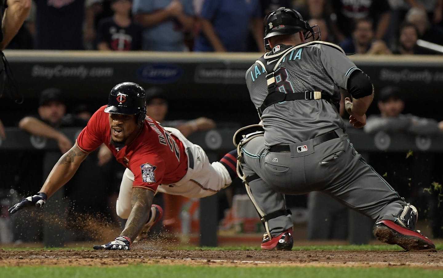 Minnesota Twins center fielder Byron Buxton (25) slid safely into home plate off an inside-the-park home run as Arizona Diamondbacks catcher Chris Iannetta (8) was late to get the tag in the bottom of the fourth.