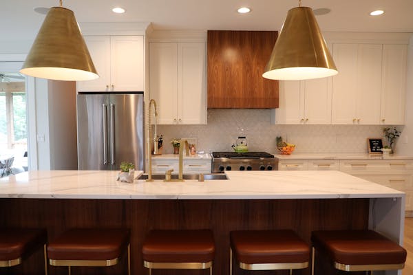 Brad and Heather Fox’s kitchen in Edina featured a mix of white and walnut cabinets. 