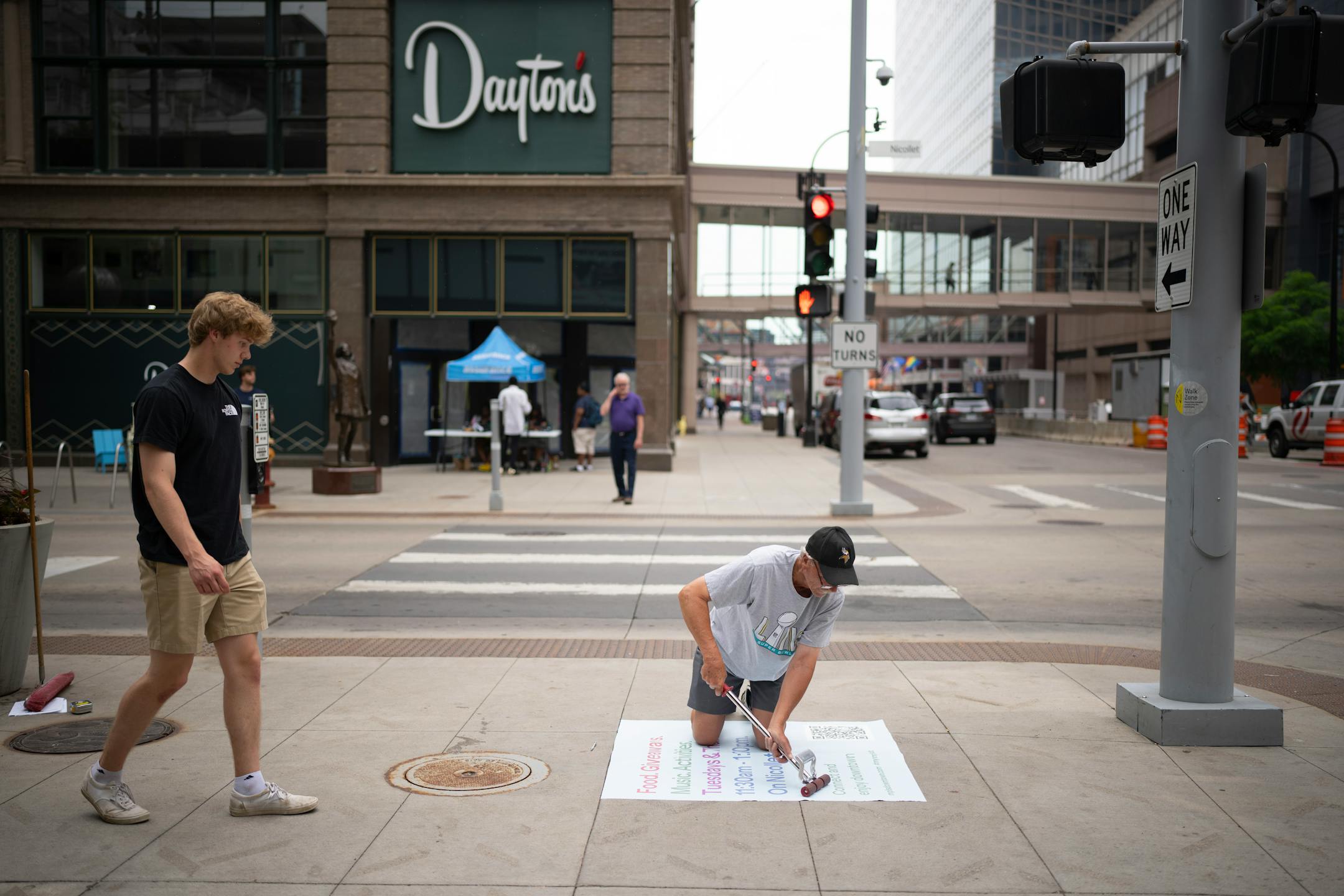 Steve Wortman installed sidewalk signage promoting summertime activities on the Nicollet Mall (Tuesdays and Thursdays from 11:30 a.m. - 1:30 p.m.) at the corner of 7th and the Nicollet Mall. Minneapolis Mayor Jacob Frey was joined at a news conference Tuesday, June 6, 2023 at Dayton's by members of his newly formed "Vibrant Downtown Storefronts Workgroup" to announce recommendations the group submitted to him.