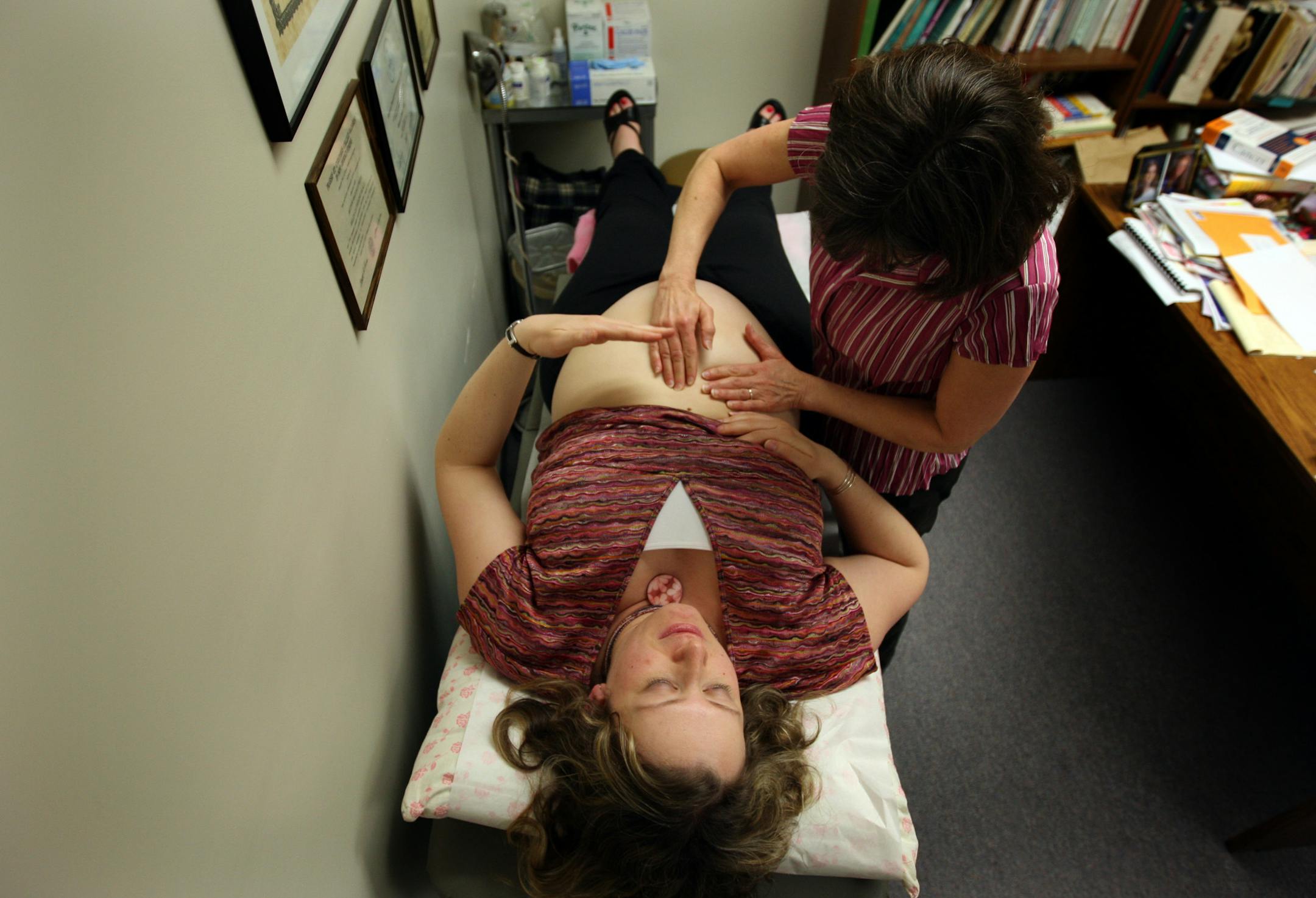 Helen Healy examined patient Svetlana Jones, 32, of Maplewood who is 30-weeks pregnant on Thursday at her office in St. Paul, MN. Helen Healy is a naturopathic doctor, who combines conventional with alternative healing methods. Twelve years ago, the state medical board tried to shut down her practice, accusing her of practicing medicine without a license. Now, for the first time, the state legislature has passed a law recognizing naturopathic doctors and giving Healy, and 25 other Minnesotans wh
