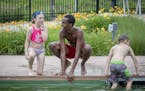 Webber Pool lifeguard Mohamed Mohamed, cq, gave swimming lessons to Mahira McClellan Sostek, 9, along with other children at the pool, Tuesday, July 9