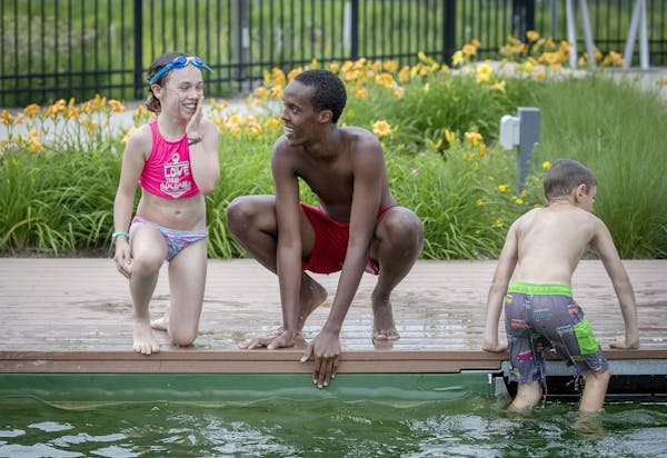 Webber Pool lifeguard Mohamed Mohamed, cq, gave swimming lessons to Mahira McClellan Sostek, 9, along with other children at the pool, Tuesday, July 9