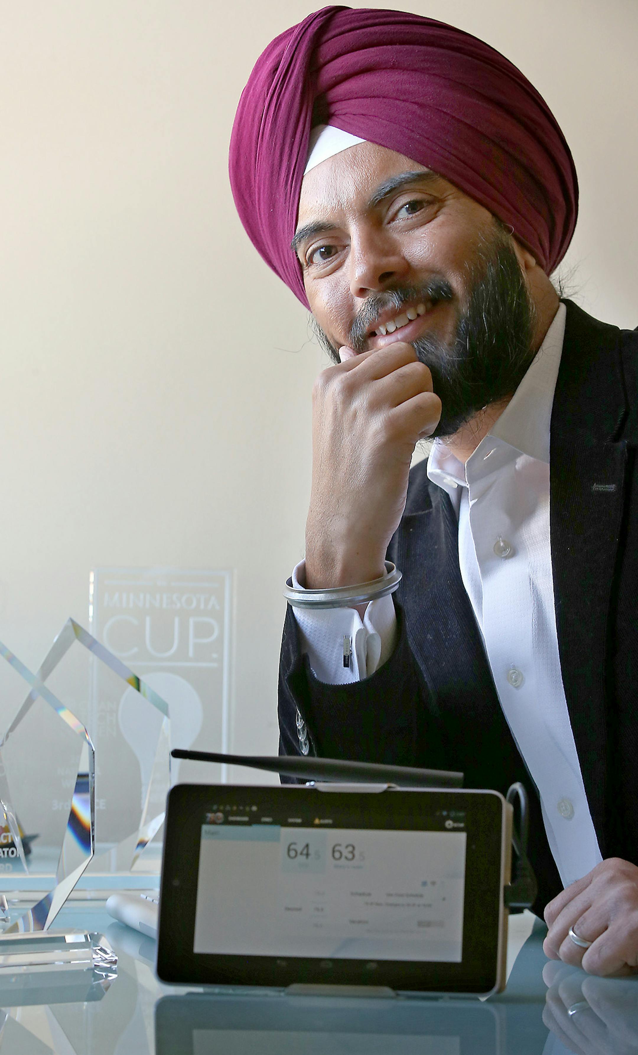 Deepinder Singh held up a computer software program that controls temperature at his Burnsville, MN office, Thursday, February 26, 2015. Singh, a computer scientist, quit his job in Detroit a f ew years ago to follow his physician-wife's career to Mankato, Minn. Their drafty house and a crying baby led him to start 75F, a software-driven company that controls room-by-room temperature and saves energy for small commercial buildings, the neglected part of the market. Singh, 40, and his 15-person c