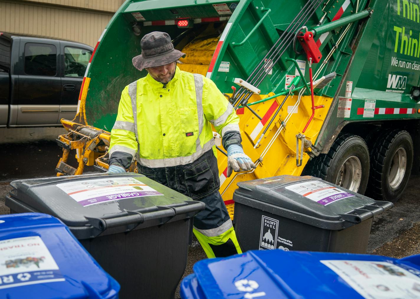 Waste Management worker Daniel Westerhaus collected trash from alleys. Some residents mistakenly used their old bins. "There are always going to be these hiccups," the city said.