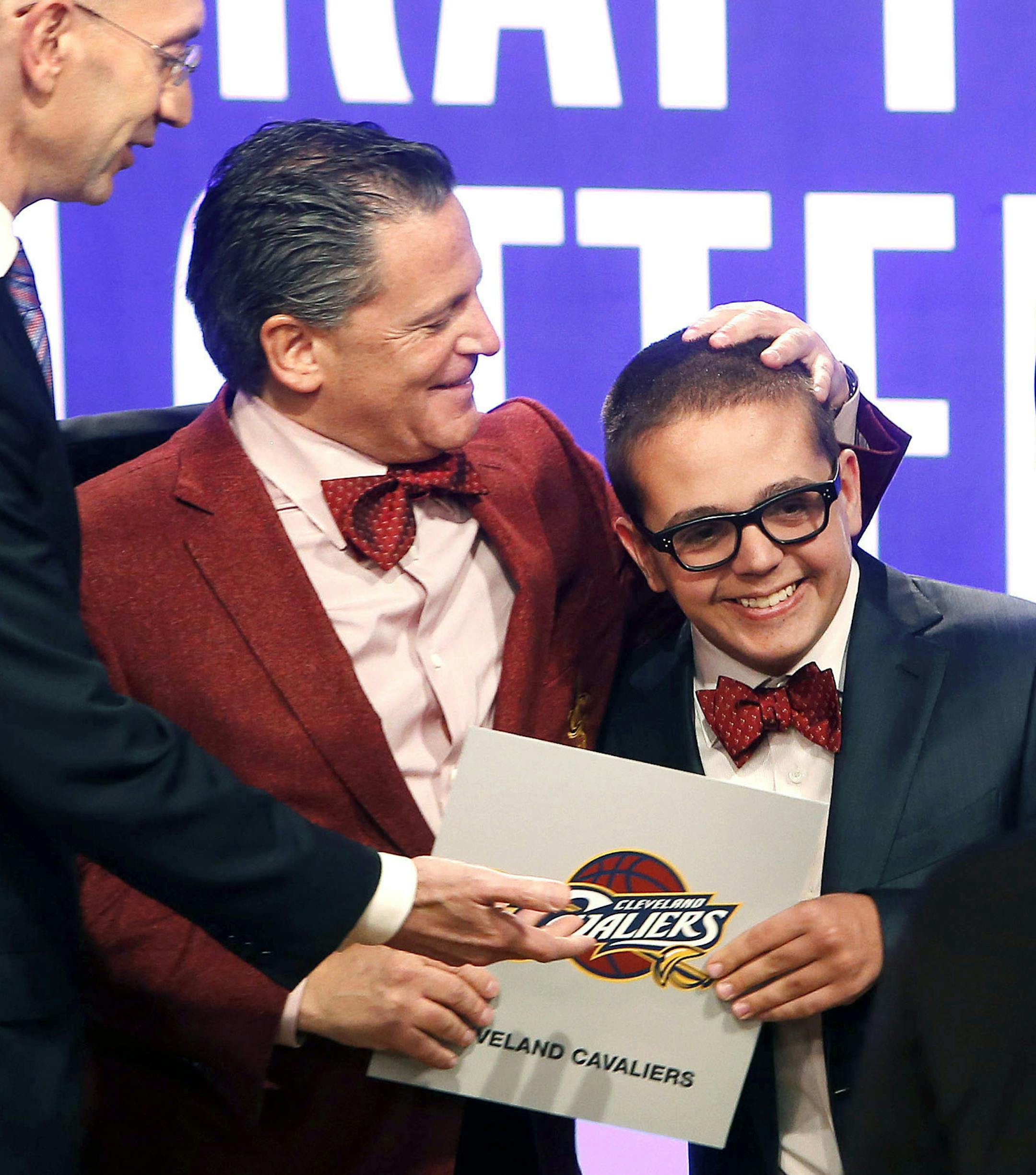 Cleveland Cavaliers owner Dan Gilbert congratulates his son Nick Gilbert after the team won the NBA basketball draft lottery, Tuesday, May 21, 2013 in New York. (AP Photo/Jason DeCrow)