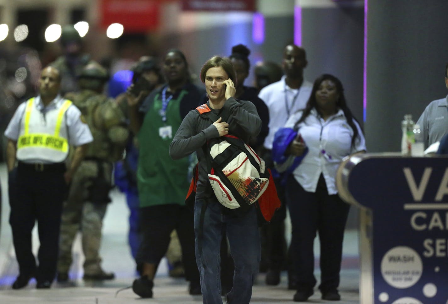 Employees and passengers walk outside terminal 2 at the scene of a deadly shooting at Fort Lauderdale-Hollywood International Airport, Friday, Jan. 6, 2017, in Fort Lauderdale, Fla. An Army veteran who complained that the government was controlling his mind drew a gun from his checked luggage on arrival at the Fort Lauderdale airport and opened fire in the baggage claim area Friday, killing several people and wounding others, authorities said.