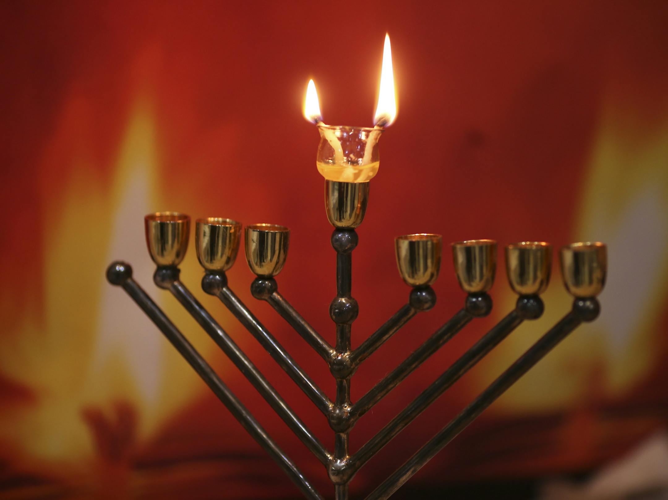 The sixth annual Dreidel Dash 5K and 10K runs were held Sunday afternoon, December 8, 2013 at the Jewish Community Center of St. Paul. Following the races there was a Post Dash Bash Community Hanukah Celebration, which organizers say is the biggest in the Twin Cities. Rabbi Gershon Grossbaum list two wicks that burned freshly pressed olive oil during a demonstration he was performing Sunday afternoon during the Post Dash Bash. ] JEFF WHEELER ‚Ä¢ jeff.wheeler@startribune.com