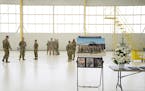 National Guard members stood in the empty hangar space where the downed UH-60 Black Hawk helicopter would have normally sat. The Minnesota National Gu
