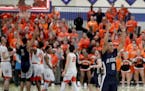 As time expires Champlin Park's Brian Strong (0) signals the win after his team defeated Osseo 79-74 for a trip to state.