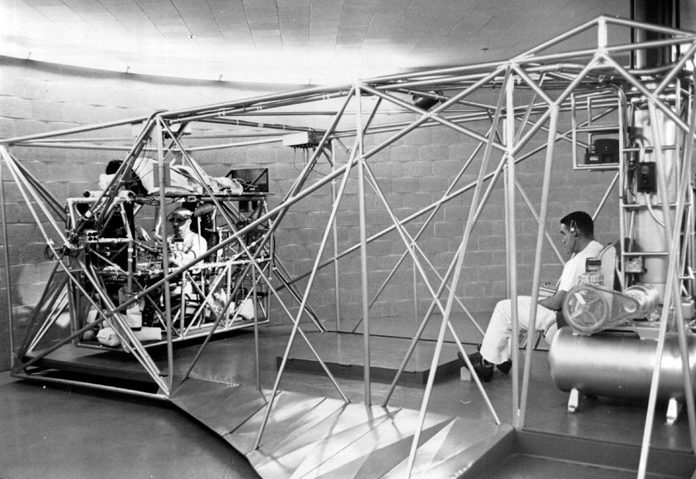 November 1, 1959 The Mayo Clinic's Big Centrifuge ready to operate Dr. Earl Wood, right, will turn on lights in front of Dr. Terence Mc Guire In the cockpit. McGuire will continue to turn them off as long as he can while under pressure from the whirling device. "Top rider" Dr. Evan Lindberg will help test McGuire's reactions. October 30, 1959 October 31, 1959 John Croft, Minneapolis Star Tribune