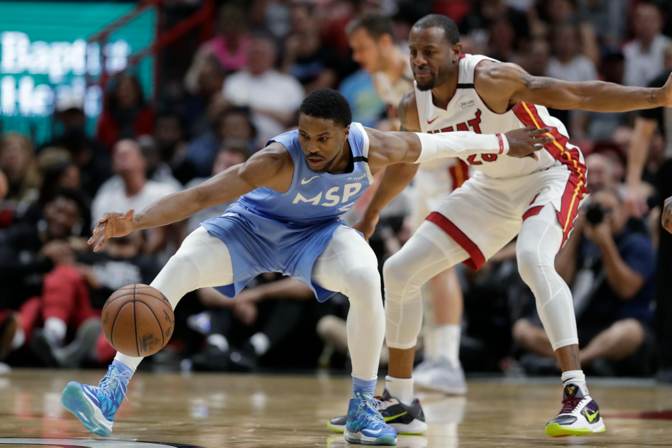 Timberwolves guard Malik Beasley, left, regains control of the ball as he is guarded by Miami guard Andre Iguodala during the second half on Feb. 26