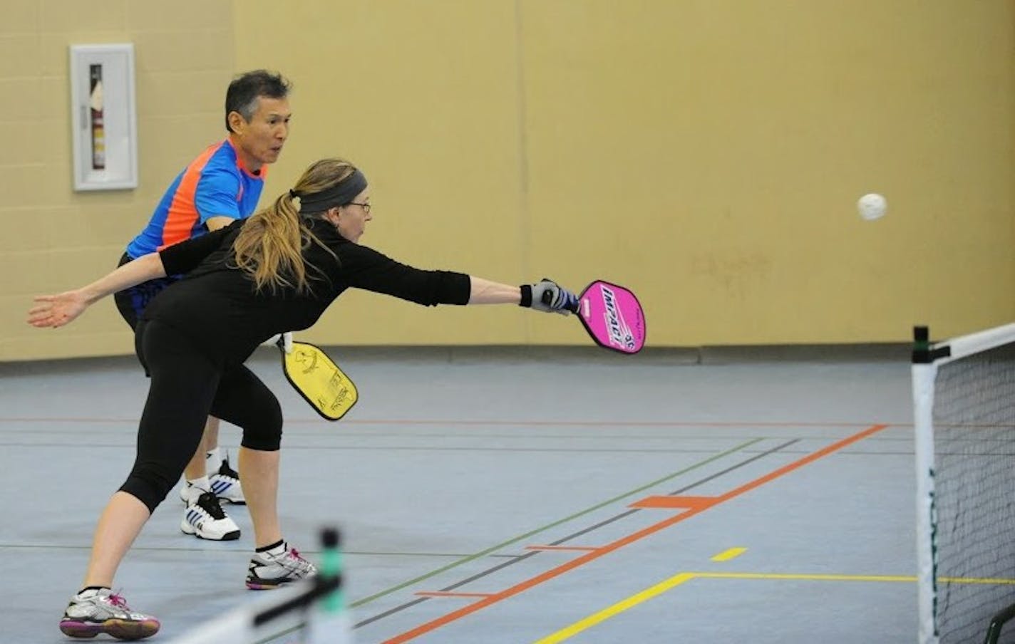 Kim Vanderstelt and Hyong Lee en route to winning gold at a recent Apple Valley Community Center tournament. Photo by RKM Photos