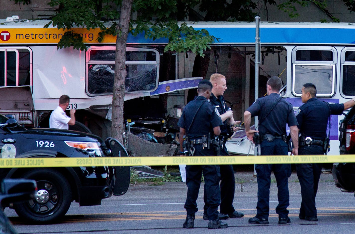 Police stand near the bus that a car collided with during a fatal crash in St. Paul on July 21, 2017. ] COURTNEY PEDROZA &#xef; courtney.pedroza@startribune.com dale st and Charles Ave, St. Paul, car bus fatal, also fire. ORG XMIT: MIN1707212104104646