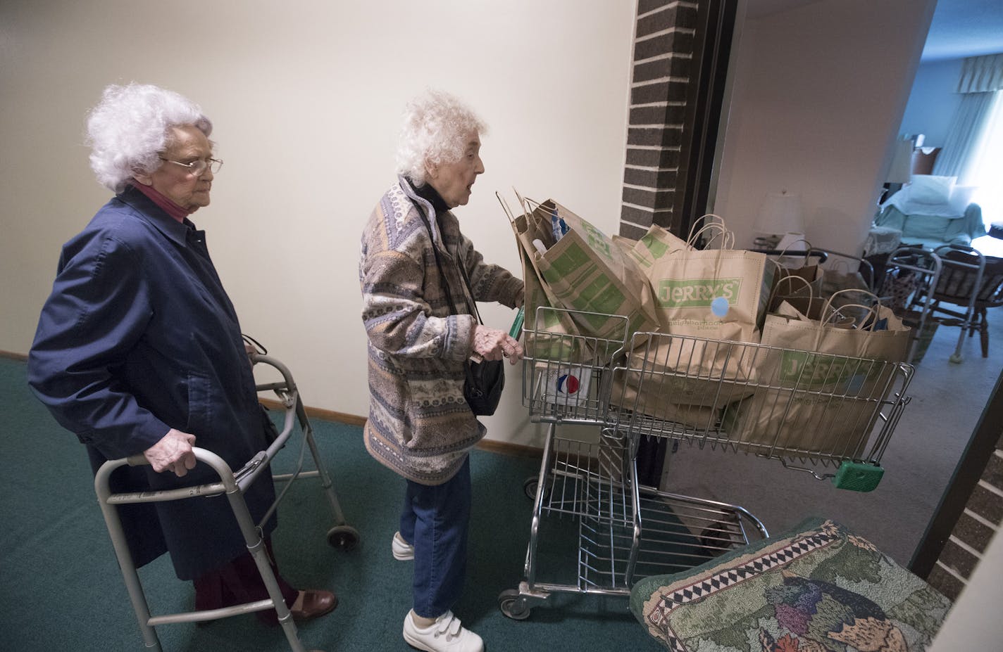 Donna Fester, 95, and her sister Norma Stromswold, 97, carried groceries into Norma&#x2019;s apartment at the Interlachen Court Apartments in Edina. Many longtime tenants of the building, who have enjoyed below-market rent for years, suddenly are confronted by new owners who are charging more.