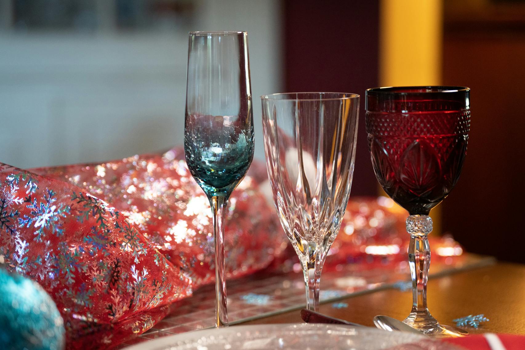A combination of three glasses at each place setting on a holiday tablescape by Amy Leyden of Kaleidoscope Table Setting.