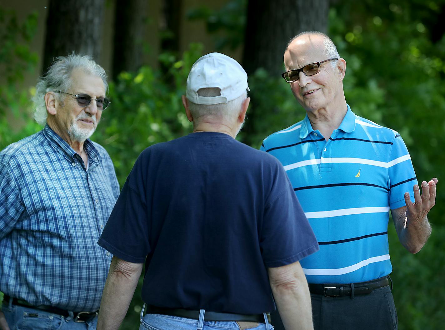 Paul Petzschke, left, and Nick Shuraleff, right, residents at the Calhoun-Isles condo complex, encountered neighbor Doug Peterson, middle near the complex where the talk immediately turned to the proposed Southwest light rail. The men stood near the Calhoun-Isles condo parking ramp where the proposed Southwest light rail train will travel within mere feet of the garage via a shallow tunnel and seen Wednesday, May 31, 2017, in Minneapolis, MN. &#xec;I&#xed;m just very concerned about how the vibr