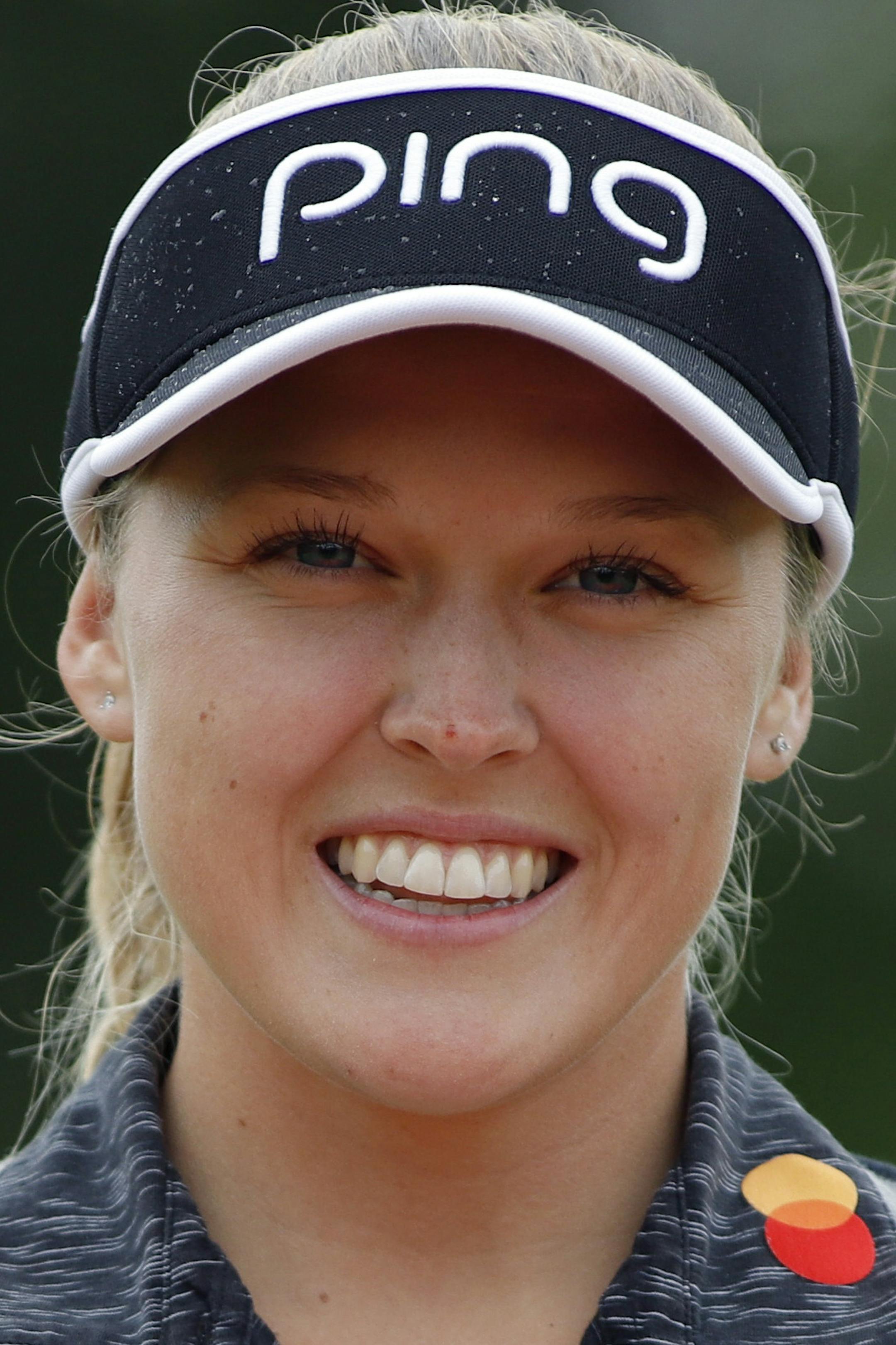 Brooke Henderson, of Canada, holds the championship trophy after winning the Meijer LPA Classic golf tournament, Sunday, June 16, 2019, in Grand Rapids, Mich. (AP Photo/Al Goldis)