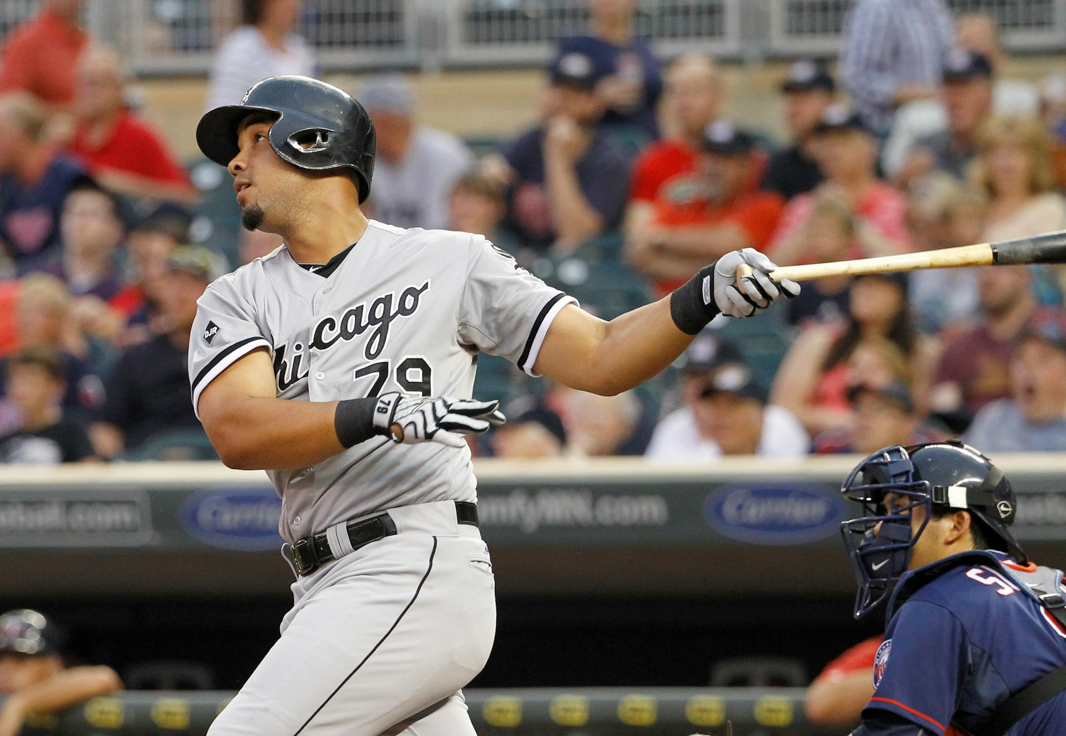 Chicago White Sox's Jose Abreu follows through on a three-run home run off Minnesota Twins starting pitcher Kevin Correia during the first inning of a baseball game in Minneapolis, Friday, July 25, 2014. (AP Photo/Ann Heisenfelt)