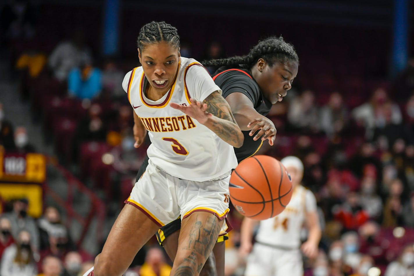 Maryland guard Ashley Owusu, right, knocks the ball away from Minnesota guard Deja Winters during the first half an NCAA college basketball game Sunday Jan. 9, 2022, in Minneapolis. (AP Photo/Craig Lassig)