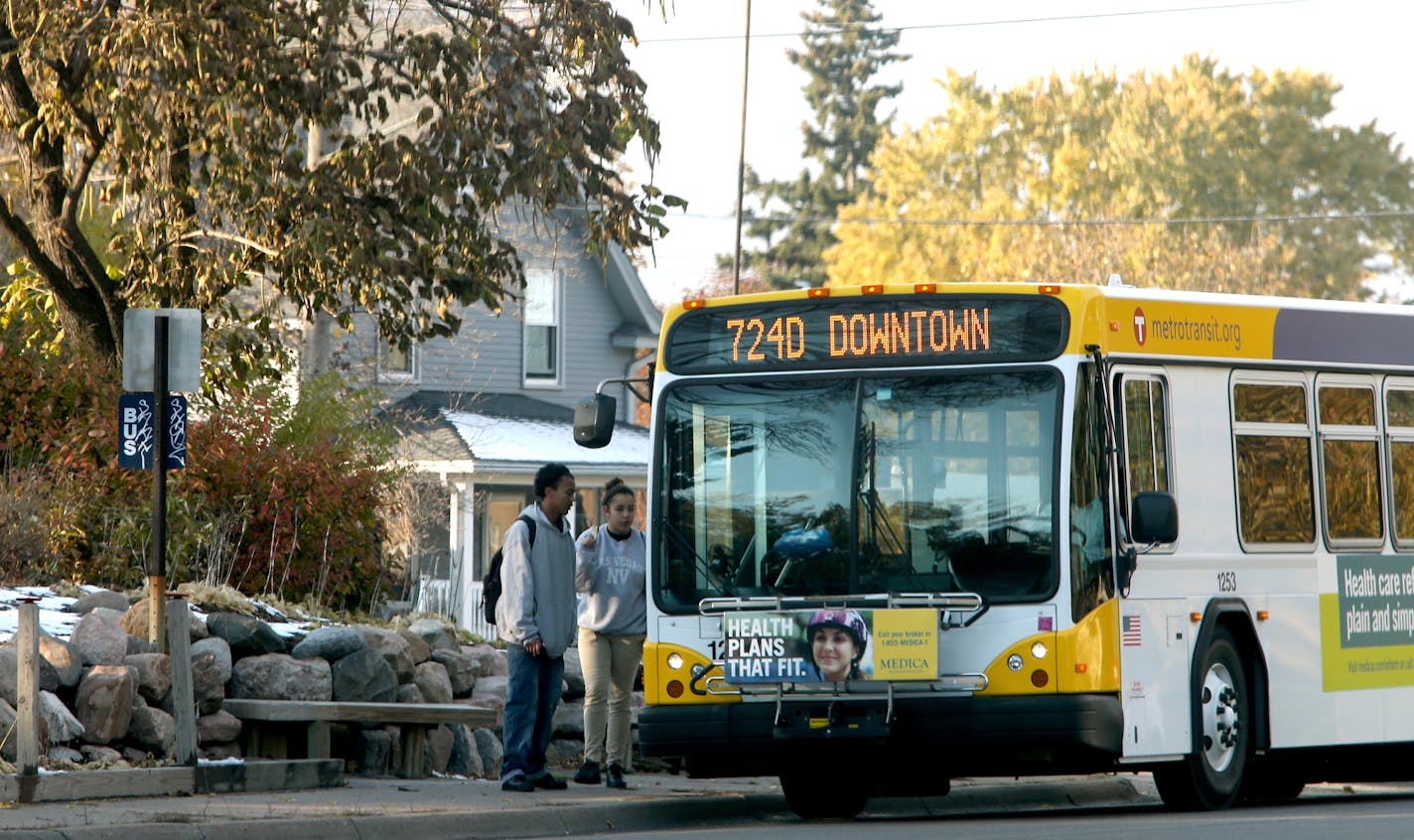 Riders board a bus in front of Jerry Evans' sons home. Jerry Evans was honored the city's act of kindness award after he built his own bus stop on his front lawn on Brooklyn Blvd. in Brooklyn Center, MN. November 7, 2013. ] JOELKOYAMA&#x201a;&#xc4;&#xa2;joel koyama@startribune It just seemed dangerous to Jerry Evans. Families with children waiting for the city bus on the thin strip of sidewalk in front of his home on busy Brooklyn Blvd. Kids fidgeted and waited just inches from the onslaught on