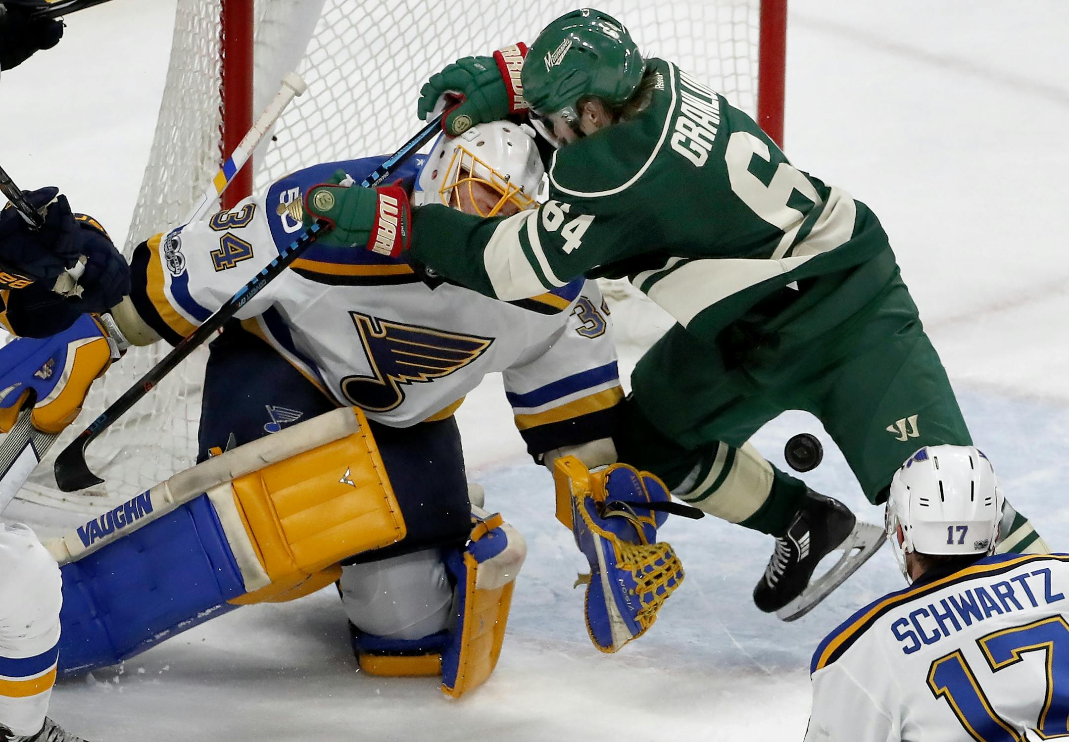 Mikael Granlund (64) got tangled up with Blues goalie Jake Allen (34) in the first period.